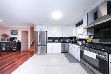 Introducing a beautifully maintained brick two-family home in - photo 5
