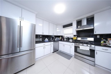 Introducing a beautifully maintained brick two-family home in - photo 8