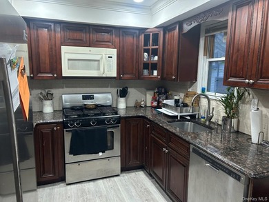 The home features a large driveway, a two-car garage, stainless - photo 6