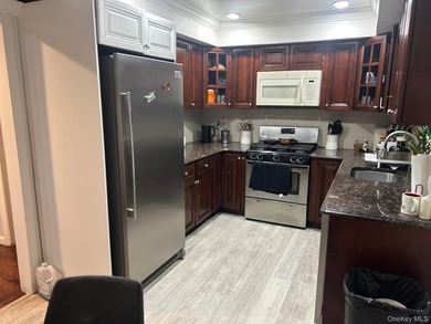 The home features a large driveway, a two-car garage, stainless - photo 8