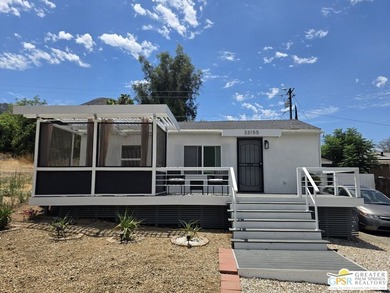 This lake view 3-bedroom, 2-bath home sits on a generous 50' x - photo 3