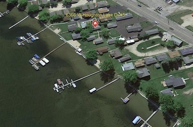 Nestled on the picturesque west shore of Houghton Lake, the - photo 26