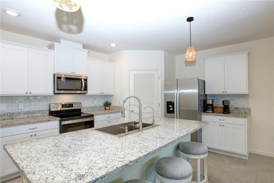 This exquisite 4-bedroom model in highly sought-after gated - photo 5