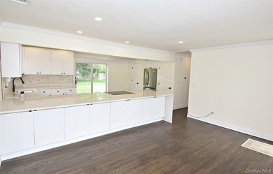The stunning brand-new eat-in kitchen is the heart of the home - photo 21