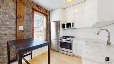 Welcome to this sun-filled, recently renovated two-bedroom home - photo 1