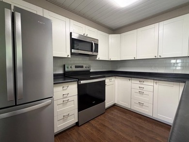 This three-bedroom, two-bathroom home sits across the bay from - photo 49