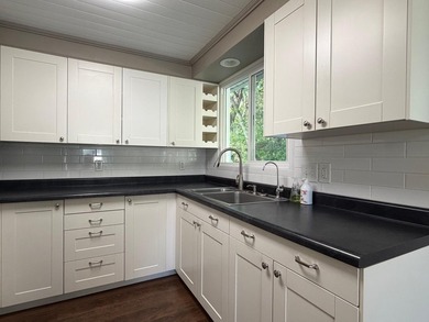 This three-bedroom, two-bathroom home sits across the bay from - photo 50