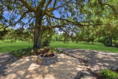 Turn down a long private driveway framed by fencing and mature - photo 18