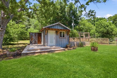 Turn down a long private driveway framed by fencing and mature - photo 21