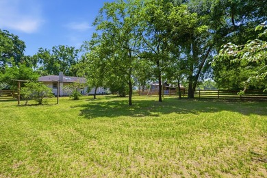 Turn down a long private driveway framed by fencing and mature - photo 24