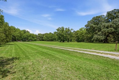 Turn down a long private driveway framed by fencing and mature - photo 25