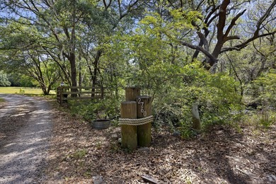 Turn down a long private driveway framed by fencing and mature - photo 29