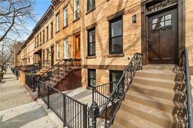 This fully renovated three-story, two-family brick townhouse in - photo 3