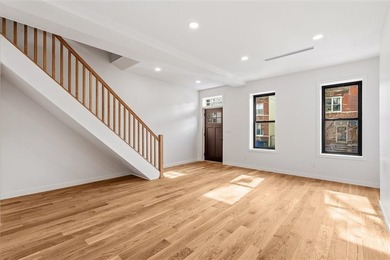 This fully renovated three-story, two-family brick townhouse in - photo 5