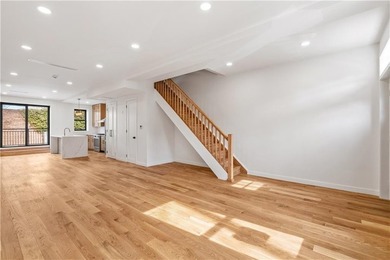 This fully renovated three-story, two-family brick townhouse in - photo 6