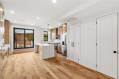 This fully renovated three-story, two-family brick townhouse in - photo 8