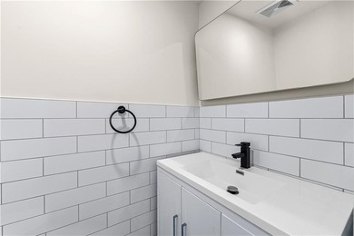 This fully renovated three-story, two-family brick townhouse in - photo 9