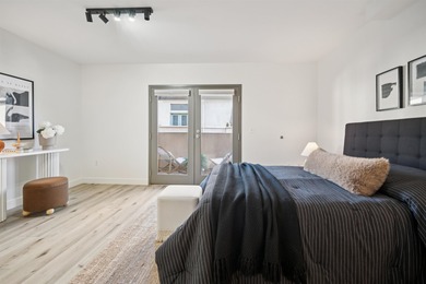 Welcome to Midtown Lofts! This chic, two-story condo unit boasts