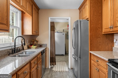 This four-sided brick, one-level home offers 3 bedrooms and 1.5