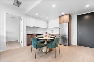 Residence 19H at Bayview Courtyard offers elevated living in a - photo 4